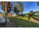 Backyard showcasing a shed and spacious grassy area at 1402 Westminster Way, Kissimmee, FL 34744