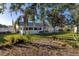 Spacious backyard with lush lawn, mature trees, and a shed at 1402 Westminster Way, Kissimmee, FL 34744
