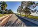 Tranquil lakeside promenade with palm trees and scenic views at 1402 Westminster Way, Kissimmee, FL 34744