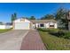 Single-Gathering home with a two-car garage and a brick walkway at 1402 Westminster Way, Kissimmee, FL 34744