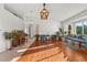 Sunlit living room featuring hardwood floors and comfortable seating at 1402 Westminster Way, Kissimmee, FL 34744