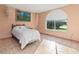 Bedroom with a twin bed, large window, and built-in shelving at 1402 Westminster Way, Kissimmee, FL 34744
