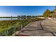 Curved lakeside walkway with metal railings offering scenic views at 1402 Westminster Way, Kissimmee, FL 34744