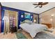 Bright bedroom with a ceiling fan and large window at 1402 Westminster Way, Kissimmee, FL 34744