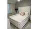 Main bedroom with a plush white upholstered bed at 3120 Paradox Cir # 102, Kissimmee, FL 34746