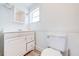 Simple bathroom with white vanity and toilet at 1015 Ohio Ave, Saint Cloud, FL 34769