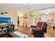 Living room with hardwood floors, comfy seating, and large TV at 1015 Ohio Ave, Saint Cloud, FL 34769