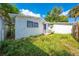 Rear view of home with detached structure and yard at 1015 Ohio Ave, Saint Cloud, FL 34769