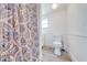 Clean bathroom with white toilet and patterned shower curtain at 1015 Ohio Ave, Saint Cloud, FL 34769
