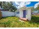 White bungalow with purple door and small yard at 1015 Ohio Ave, Saint Cloud, FL 34769