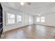 Open living room with hardwood floors and large windows at 1015 Ohio Ave, Saint Cloud, FL 34769