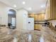 Modern kitchen featuring granite countertops and light wood cabinets at 3050 Pirates Retreat Ct # 108, Kissimmee, FL 34747