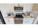Stainless steel appliances and white shaker cabinets at 4227 Sawtooth Ct, Tavares, FL 32778