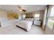 Spacious Primary bedroom with plush bedding and large windows at 4227 Sawtooth Ct, Tavares, FL 32778