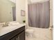 Clean bathroom with single vanity, shower/tub combo, and gray curtain at 2769 Bookmark Dr, Kissimmee, FL 34746