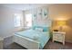 Main bedroom with a white bed frame and teal bedding at 2505 Dharma Cir, Kissimmee, FL 34746