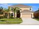 Two-story house with a large driveway and landscaping at 2505 Dharma Cir, Kissimmee, FL 34746