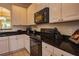 Kitchen features black appliances and white cabinets at 2505 Dharma Cir, Kissimmee, FL 34746