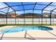 Relaxing kidney-shaped pool with screened enclosure at 2505 Dharma Cir, Kissimmee, FL 34746
