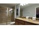 Bathroom with double vanity, granite countertop, and large shower at 8860 Candy Palm Rd, Kissimmee, FL 34747