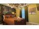 Bedroom with a jungle theme, full-size bed, and unique lighting fixture at 8860 Candy Palm Rd, Kissimmee, FL 34747