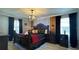 King-size bed, dark wood furniture, and decorative lighting in this bedroom at 8860 Candy Palm Rd, Kissimmee, FL 34747
