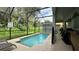 Inviting screened pool with lounge chairs and patio furniture at 8860 Candy Palm Rd, Kissimmee, FL 34747