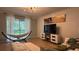Relaxing living area with a hammock and access to a backyard patio at 8860 Candy Palm Rd, Kissimmee, FL 34747
