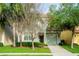 Two-story house with light teal exterior and landscaping at 8860 Candy Palm Rd, Kissimmee, FL 34747