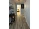 Long hallway with wood-look floors and artwork at 8860 Candy Palm Rd, Kissimmee, FL 34747