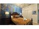Comfortable bedroom with an ocean-themed wall and double closet at 8860 Candy Palm Rd, Kissimmee, FL 34747