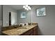 Bathroom features double sinks, granite countertop, and large mirror at 8860 Candy Palm Rd, Kissimmee, FL 34747