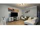 Bright living room with a comfortable sectional sofa and large TV at 8860 Candy Palm Rd, Kissimmee, FL 34747