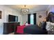 Spacious bedroom with a king-size bed, dark wood furniture, and decorative lighting at 8860 Candy Palm Rd, Kissimmee, FL 34747