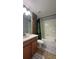Clean bathroom with a bathtub, shower, and updated vanity at 8860 Candy Palm Rd, Kissimmee, FL 34747