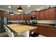 Spacious kitchen with island, dark wood cabinets, and granite counters at 8860 Candy Palm Rd, Kissimmee, FL 34747