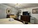 Spacious bedroom with a king-size bed, dresser, and large TV at 8860 Candy Palm Rd, Kissimmee, FL 34747