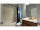 Clean bathroom with a shower/tub combo and wood vanity at 8860 Candy Palm Rd, Kissimmee, FL 34747