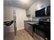 Modern kitchen with stainless steel appliances and gray cabinets at 3045 Aaron Burr Ave # 10, Winter Park, FL 32792