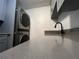 Laundry room with modern washer and dryer, gray countertops at 3045 Aaron Burr Ave # 10, Winter Park, FL 32792