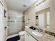Bathroom with granite countertop, shower, and toilet at 119 Talavera Ln, Kissimmee, FL 34758