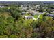 Aerial view of a house with a large backyard and a neighborhood in the background at 119 Talavera Ln, Kissimmee, FL 34758