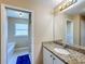 Bathroom with granite countertop, sink, and view of bathtub at 119 Talavera Ln, Kissimmee, FL 34758
