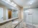 Bathroom with granite countertop, large walk-in shower, and tiled floors at 119 Talavera Ln, Kissimmee, FL 34758