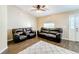 Living area with leather sofas and wood-look tile flooring at 119 Talavera Ln, Kissimmee, FL 34758