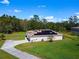 Aerial view showing house, solar panels, and driveway at 119 Talavera Ln, Kissimmee, FL 34758