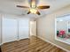 Bedroom with ceiling fan, double closet, and window at 119 Talavera Ln, Kissimmee, FL 34758