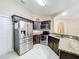 Modern kitchen with stainless steel appliances and dark wood cabinets at 119 Talavera Ln, Kissimmee, FL 34758