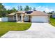 Single-story home with attached garage and solar panels at 119 Talavera Ln, Kissimmee, FL 34758