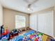 bedroom featuring a Mickey Mouse rug, toys, and a ceiling fan at 119 Talavera Ln, Kissimmee, FL 34758